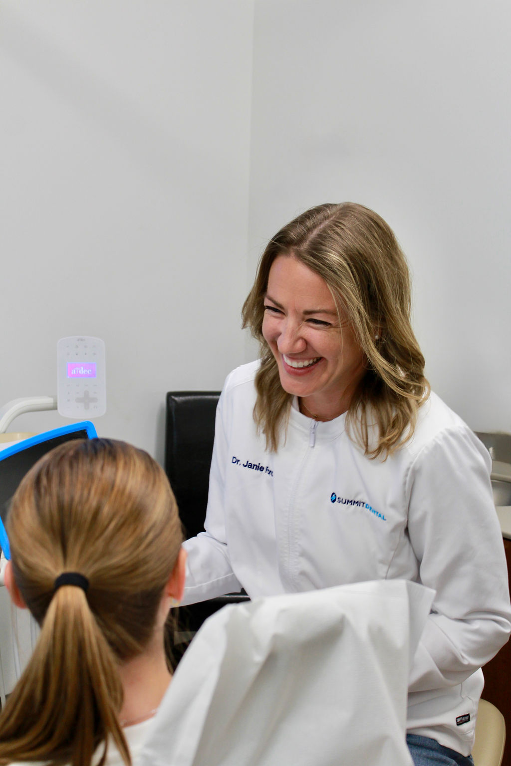 Dr. Janie Ford smiling with a young patient at Summit Dental in Rosemount, MN